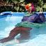 Mara sunbathing and swimming in the pool wearing sexy shiny nylon rainwear and a raincape (Pics)