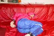 Sonja tied and gagged on a bar wearing a sexy blue shiny nylon rain pants and a pink down jacket (Pics)