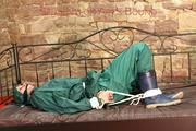 Pia tied, gagged and hooded in a princess bed wearing sexy shiny green rainwear (Pics)