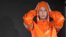 Watching sexy Pia putting on an orange AGUlike rainwear combination feeling comfortable in it and posing for you (Video)