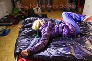 Sonja tied and gagged on bed with cuffs wearing a sexy lightblue rain pants and a purple down jacket (Pics)