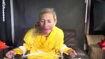 Sandra being tied and gagged on a hairdresser´s chair wearing sexy yellow shiny nylon rainwear being double hooded (Video)