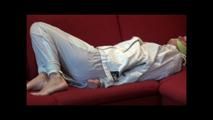 Pia tied and gagged on a sofa wearing a shiny white rainsuit (Video)