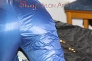 Pia wearing a sexy oldschool shiny nylon AGU rainwear combination posing and lolling on bed (Pics)