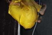 Watching sexy Sandra wearing a hot yellow shiny nylon rainwear combination during her housework (Pics)