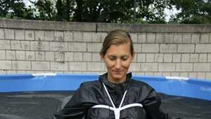 Watch Sandra beeing bound tighly hooded and gagged in her shiny nylon Rainwear