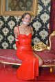 Miss Scarlett bound and gagged in a long red Latex dress