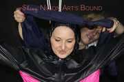 Sexy Mara tied, gagged and hooded overhead on hands and feet with ropes and a cloth gag wearing a sexy black/pink rainwear combination (Pics)