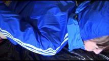 Mara tied, gagged and hooded on a sexy black covered sofa wearing a blue rain jacket and pink rain pants (Video)