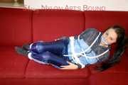 Lucy wearing a blue shiny nylon pants and an oldschool blue rain jacket tied and gagged with ropes on a sofa (Pics)