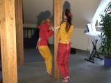 a video with two of our archive girls bound and gagged in shiny nylon rainsuits