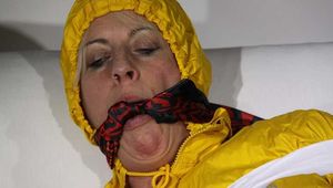 Watching Pia being tied and gagged with tape and a cloth gag wearing sexy yellow shiny nylon rainwear (Pics)