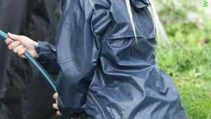 Watch Chloe enjoying her shiny nylon Rainwear doing some watering in the garden