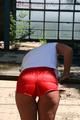 Stella posing outdoor wearing a supersexy red shiny nylon shorts and a white top (Pics)
