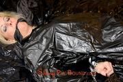 Pia tied and gagged on bed wearing a shiny black PVC sauna suit (Pics)