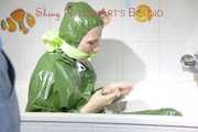 MARA ties and gagges herself in a bath tub cuffs and a cloth gag wearing a super sexy super shiny green rubber rainsuit (Pics)