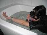 Sandrine scuba diving in the bath tub wearing a Swatch