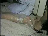 26 Yr OLD K-MART CLERK MUMMY PLASTIC WRAPPED NAKED, WRAP TAPE GAGGED, SPANKED & FOOT TICKLED (D38-16)