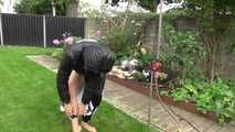 Watching Aiyana wearing a sexy black shiny nylon rainpant and a black shiny nylon down jacket trying the garden shower  (Video)