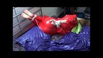 Samantha tied and gagged on bed wearing a shiny red sauna suit (Video)