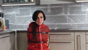 Miss Amira in sexy PVC Catsuit and raincoat bound and gagged