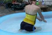 Sexy Sonja wearing a darkblue shiny nylon shorts and a yellow top enjoying the water in the swimming pool (Pics)