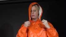 Watching sexy Pia putting on an orange AGUlike rainwear combination feeling comfortable in it and posing for you (Video)