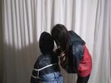 two of our archive girls tied and gagged in shiny nylon rainwear