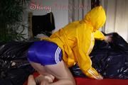 Sonja wearing a sexy blue shiny nylon shorts and a yellow rain jacket preparing her bed (Pics)