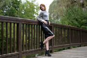 Miss Petra in a hot vinyl skirt, high heels and transparent blouse at photo shooting