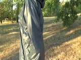 Get a Video with Sandra walking in her shiny nylon Rainsuit at a very hot and sunny day