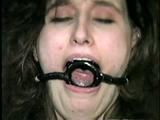 ERICA IS RING GAGGED, MOUTH STUFFED, CLEAVE GAGGED & TIED WITH BLACK NYLON ROPE (D36-10)