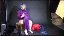 Mara wearing sexy purple rainwear trying on a black down pants and a red down jacket infront of the camera (Video)