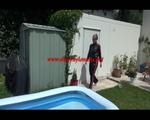 Mara wearing a shiny black/pink adidas training suit playing with water in the pool (Video)