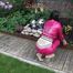 Watching Aiyana wearing supersexy pink shiny nylon rainwear while planting flowers in the garden (Pics)