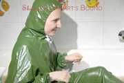 MARA ties and gagges herself in a bath tub cuffs and a cloth gag wearing a super sexy super shiny green rubber rainsuit (Pics)