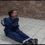 Jill tied and gagged on the floor in an old cellar wearing a shiny blue PVC sauna suit (Video)