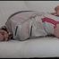 Jill tied and gagged on a white sofa wearing a white nylon shorts and a white rain jacket (Video)