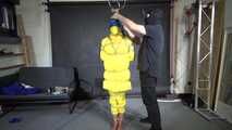 Ms Ungeniert tied, gagged and hooded in shiny nylon yellow Downjacket