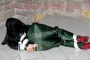 Jill tied, gagged and hooded on a cellar floor wearing a shiny green rain pants and a shiny black down jacket (Pics)