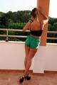 Stella during a lap dance wearing a green shiny nylon shorts and a black top and high heels (Pics)