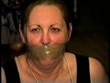 46 Yr OLD REAL ESTATE AGENT'S IS MOUTH STUFFED, WRAP TAPE GAGGED,  HANDGAGGED, TOE-TIED WEARING NYLON STOCKINGS AND IS TIGHTLY BALL-TIED WITH ROPE ON THE FLOOR (D66-06)
