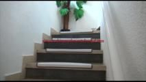 Jill tied and gagged on a stairrail wearing a sexy shiny red shorts with shadow stripes and a top (Video)
