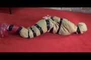 Jill tied, gagged and hooded lying on the floor wearing sexy shiny nylon golden rainwear (Video)