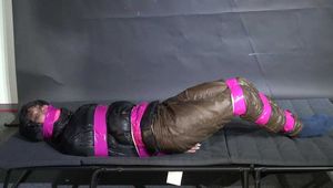 Marie M bound and gagged in shiny nylon Downwear trying to escape