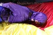 Sonja tied, gagged and hooded with ropes and a cloth gag on the sofa wearing a supersexy blue rain pants and a purple rain jacket (Pics)