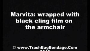 [From archive] Marvita is mummified in black cling film (video)
