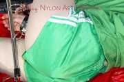 ***HOT HOT HOT*** LUCY tied and gagged on a bed with a bar and a cloth gag wearing sexy green shiny nylon shorts and a green rain jacket (Pics)