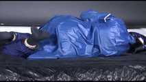 Lucy ties and gagges herself with cuffs on a bed wearing sexy blue shiny nylon rainwear (Video)