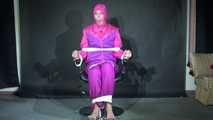 Sexy Pia tied and gagged with ropes and a clothgag on a hairdresser´s chair wearing a sexy pink shiny nylon downsuit (Video)